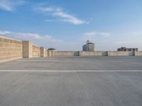 several large empty parking spaces in the city with buildings nearby in front of them -