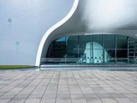 an entrance to an architectural building with circular windows that have an arch in it,