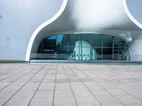 an entrance to an architectural building with circular windows that have an arch in it,