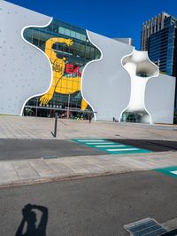 there is a yellow bear on the outside wall of the building that houses the olympic museum