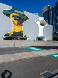 there is a yellow bear on the outside wall of the building that houses the olympic museum