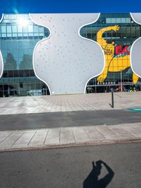 there is a yellow bear on the outside wall of the building that houses the olympic museum