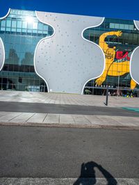 there is a yellow bear on the outside wall of the building that houses the olympic museum