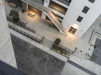 a skateboarder is skateboarding near an industrial building's stairway and stairs