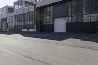 a city side view with an industrial building and an empty street in the foreground