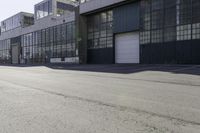 a city side view with an industrial building and an empty street in the foreground