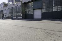 a city side view with an industrial building and an empty street in the foreground