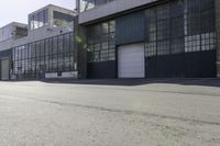 a city side view with an industrial building and an empty street in the foreground