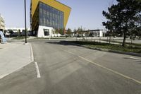 there is a car that is parked outside the building and has trees to the side