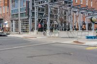 a building with a fence near the side of it on the street corner of the city