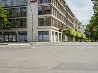 a street with two red traffic lights and some buildings in the back ground is a red no right turn sign