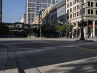 people walking across a street in a city area near tall buildings and a sign that reads no parking