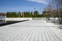 the walkway is lined with gravel as well as greenery on either side and water in the center