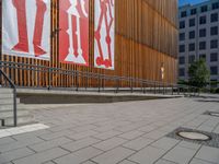 a group of people riding skateboards near wooden panels and stairss with artwork on them