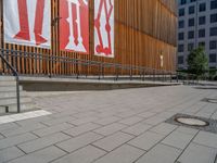 a group of people riding skateboards near wooden panels and stairss with artwork on them