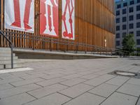 a group of people riding skateboards near wooden panels and stairss with artwork on them