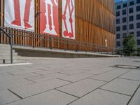 a group of people riding skateboards near wooden panels and stairss with artwork on them