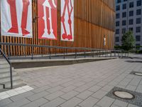 a group of people riding skateboards near wooden panels and stairss with artwork on them