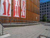 a group of people riding skateboards near wooden panels and stairss with artwork on them