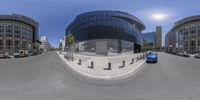 360 lens image of parking lot and buildings in urban area in summer day time with sunlight