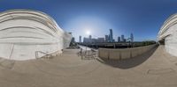 the view of an urban area from a fisheye lens of circular buildings and a sky line