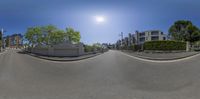 360 - view image of street in urban area in front of buildings and fenced in park