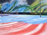 a colorful skate park with a person jumping up high in the air on the ground