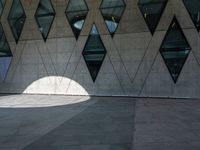 a shadow of a man walking with his back towards the camera of the building as it is lit by the light