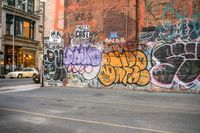 a wall with graffiti has been vandalized in the city corner of a street