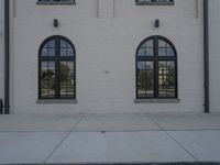 a large building with arched windows in the middle of it and a stop sign next to the building