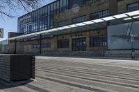 a black box sitting on a city street near a building and trees in front of it