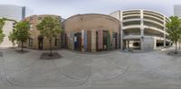 a spherical 360 photograph shows a courtyard with buildings and trees, while the building is in the middle