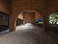 an archway that is in an empty building with stone and brick arches in between it