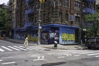 a cross walk with lots of graffiti painted on the walls of it and a building