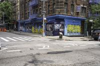 a cross walk with lots of graffiti painted on the walls of it and a building