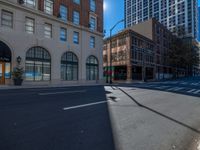 the empty street is next to some building and there are no cars passing through it