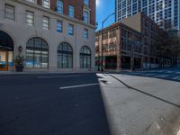 the empty street is next to some building and there are no cars passing through it