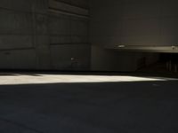 a young man riding on a skateboard inside of a building or garage by himself
