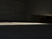 a young man riding on a skateboard inside of a building or garage by himself