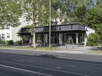 a bus parked on the side of the street in front of a building and many trees