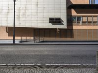 a building sitting on the side of a road with a parking meter and lamp post