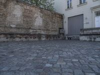 there is a bench and a door near a large building with windows in the back