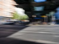 a street with two trains on it and a few people walking under an overpass