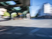 a street with two trains on it and a few people walking under an overpass