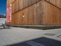 a group of people riding skateboards near wooden panels and stairss with artwork on them