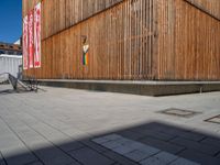 a group of people riding skateboards near wooden panels and stairss with artwork on them