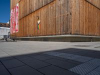 a group of people riding skateboards near wooden panels and stairss with artwork on them