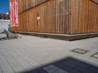 a group of people riding skateboards near wooden panels and stairss with artwork on them