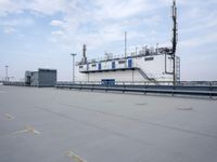 a boat is parked in an empty parking lot near an air port on the water