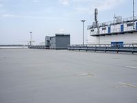 a boat is parked in an empty parking lot near an air port on the water